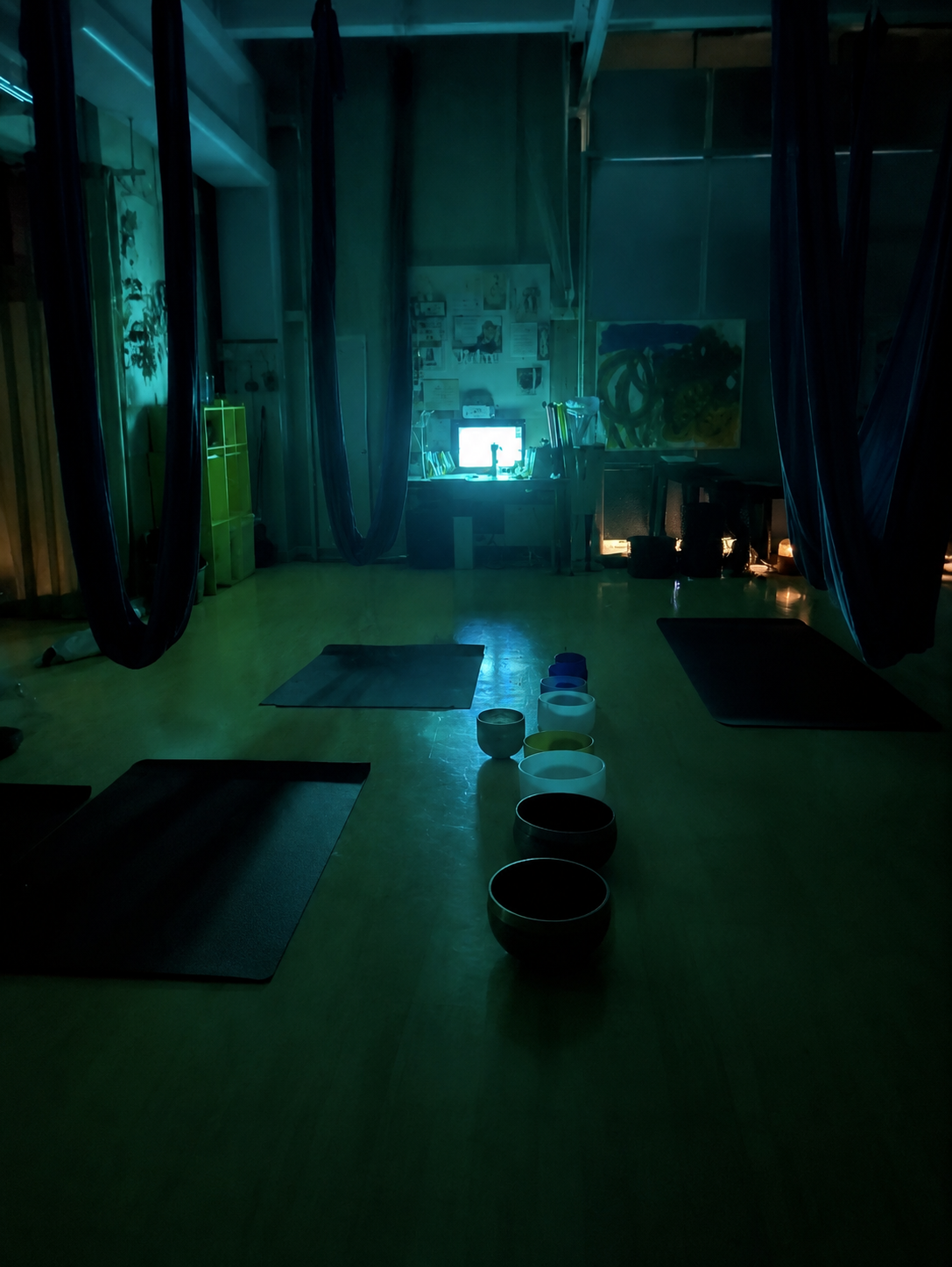 Sound bowls and aerial silks in the softly lit studio